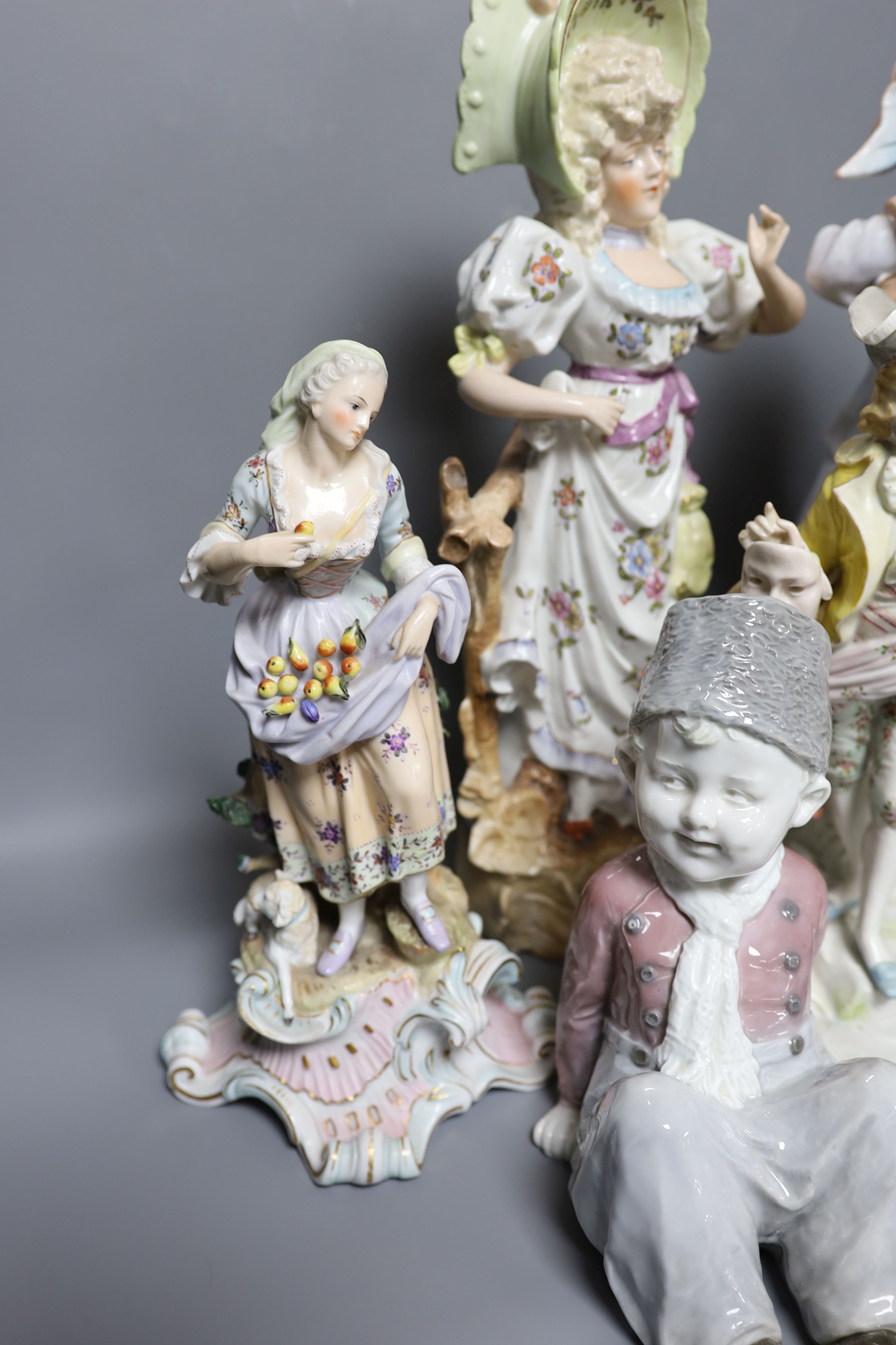 A collection of German and French porcelain figurines, tallest 39.5cm high